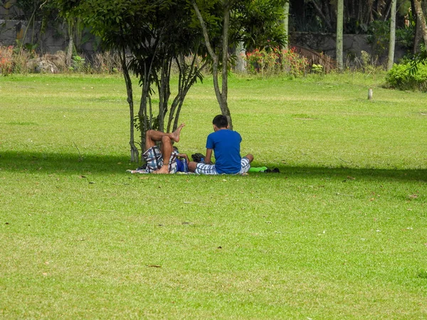 parkın çimenlerinde yatan insanlar