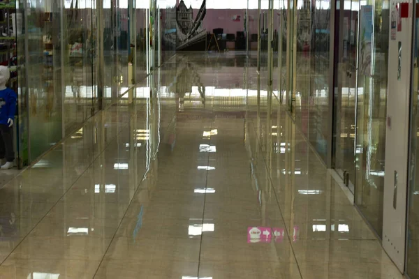 In a modern store, the floors are made of shiny ceramic tiles and glass display cases. High quality photo