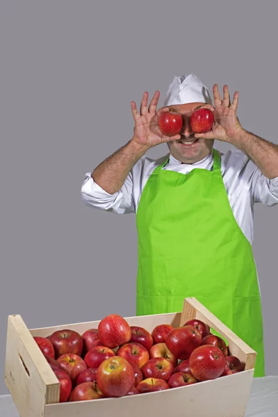 水果小贩在他的眼睛上放了两个红苹果开玩笑 — 图库照片
