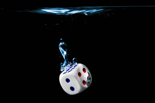 Dice with the number two face in the water with black background