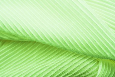 Doku yivli olduğunu, yön farklıdır, kumaş arka plan ekranda pilili yakın çekim. Nane renk