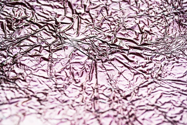 Crumpled foil background screensaver. Brown metal foil background