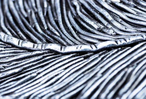 Metallic backgrounds. Background with silver pattern, top view. Decor of metal, wire, diagonally stripe, imitation of a feather. The report of the picture on the main. Background metal, silver. The background is blurred