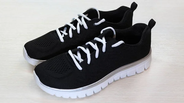 Zapatillas deportivas unisex negras con suela blanca y cordones blancos en w — Foto de Stock