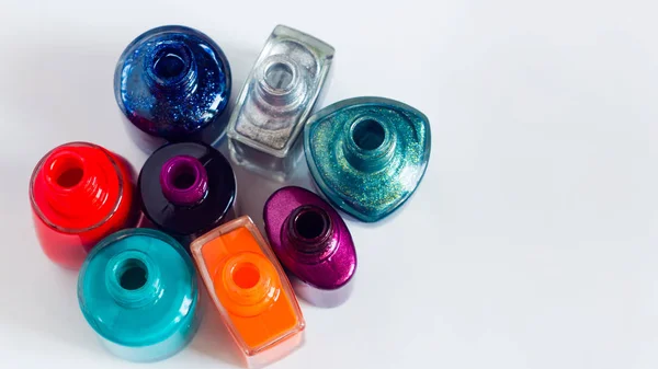Scattered nail Polish in the beauty salon. The choice of color nail Polish for manicure or pedicure. gel Polish for manicure on a white table, isolated