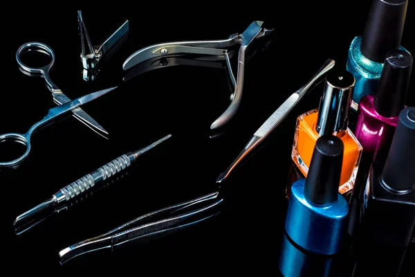 Manicure and pedicure tools on black background, isolated. Equipment for beauty shop, cosmetic salon or beauty parlour. Manicure tools in the beauty salon. Equipment for manicure or pedicure salon. — Stock Photo, Image