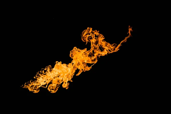 Fire in the shape of a figure with a face. Fire flames on black background isolated. fire patterns