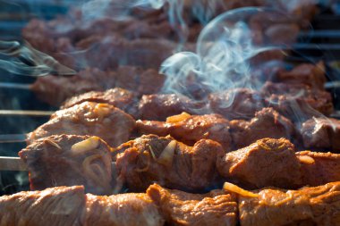 Izgarada dumanla barbekü yapmak. Soğanlı taze marine edilmiş et pişir. Izgarada marine edilmiş barbekü kömürün üstünde hazır. Günaydın BBQ. Izgarada et.