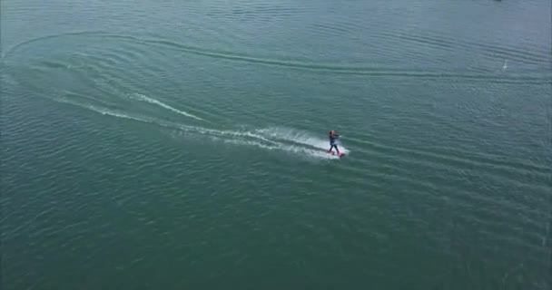 Flying over girl wakeboarding in wake park. — Stock Video