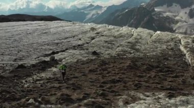 Elbrus bölgesindeki Buzul 'da koşan bir grup insan üzerinde havadan uçuş.