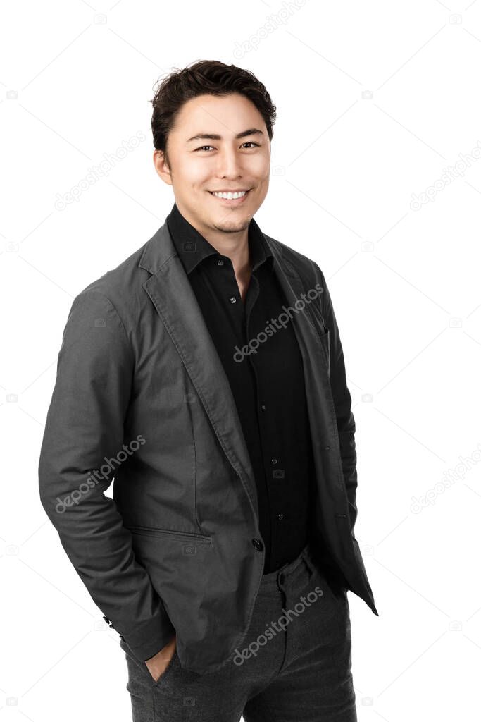 A half body shot of a very attractive Asian guy withsilky black hair and wearing a grey jacket looking laidbackand smiling towards the camera. 