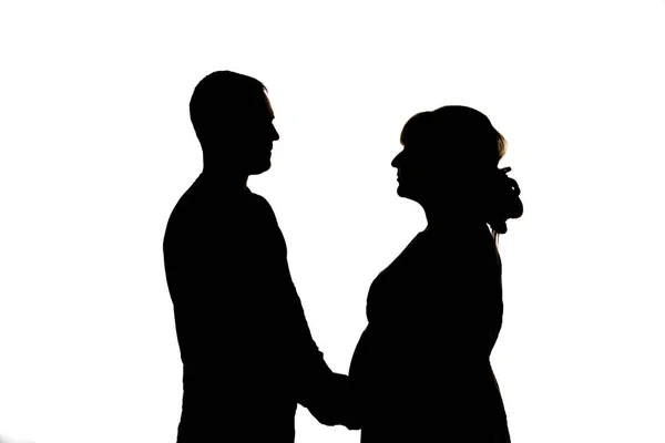 一个孕妇和一个男人 黑色剪影在白色背景 — 图库照片