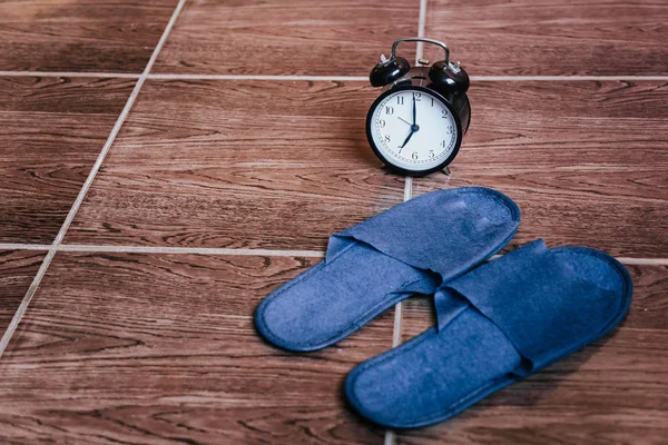 Blue Slippers and alarm clock. Bedtime. The view from the top.