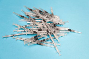 İğneli şırıngalar. Uyuşturucu bağımlılığı, mavi arka planda steroidler. Hastalık sırasında ilaç kullanırız.