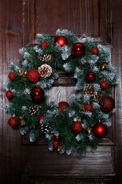 Christmas wreaths and decoration on the doors of the house. Christmas wreath on wooden door decoration.