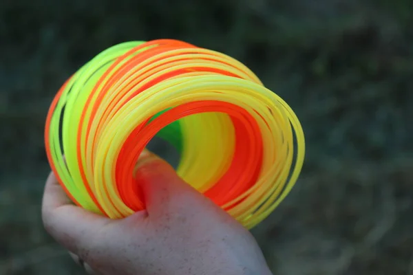 Neon strings for grass trimmer in woman\'s hand