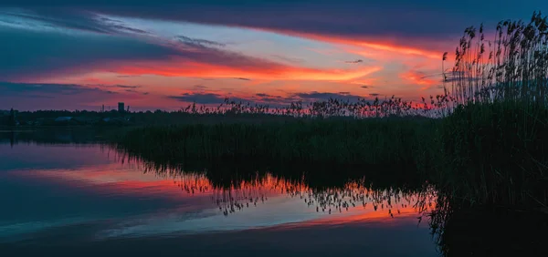 Traumhafter Sonnenuntergang mit Wolken, die sich im Wasser des Sees spiegeln — Stockfoto