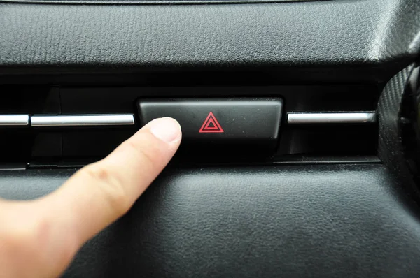 cropped shot of man pushing emergency button in car
