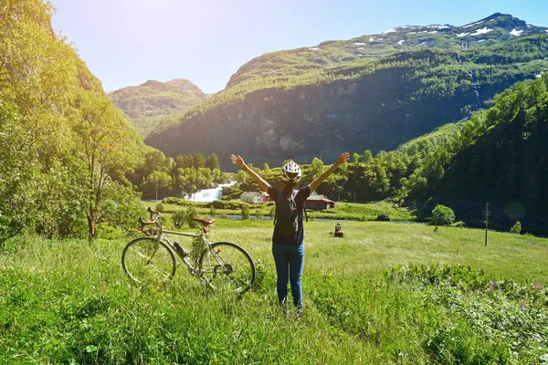 people ride bicycle on mountain road at flam Norway