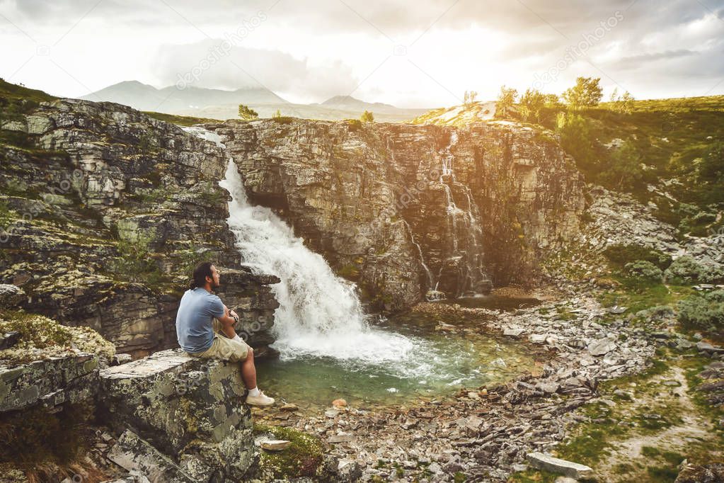 Man on a cliff at storulfossen Norway