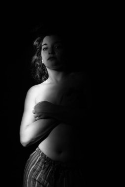 Mujer desnuda posando en estudio, fotografa en blanco y negro.