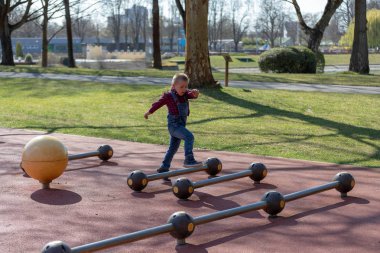 Küçük çocuk yaz parkta oynamak. Çocuk renkli giysileri ile