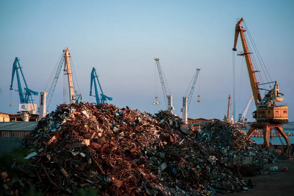 Garbage pile in trash dump or junkyard, metal crane garbage consumption junkyard scarp, Global warming, Ecosystem and environment concepts and background.