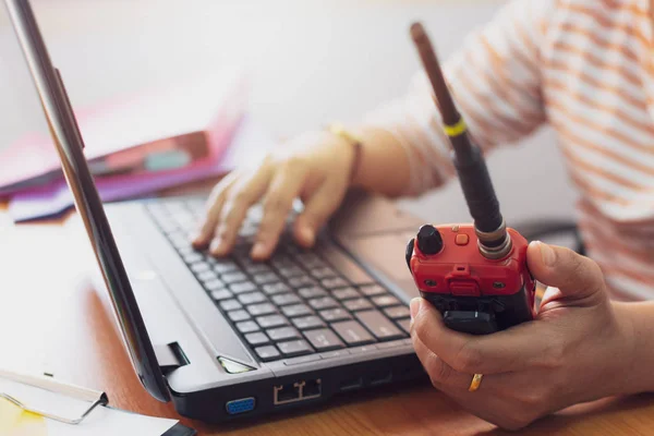 Female radio operator using Walkie - Talkie to communicate with Stock Photo