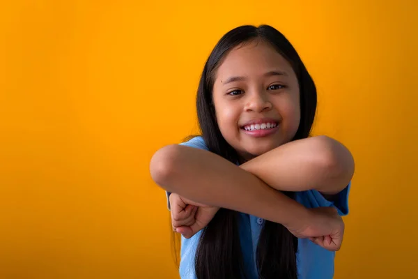 Smiling asian girl portrait isolated on yellow background. — Stok Foto