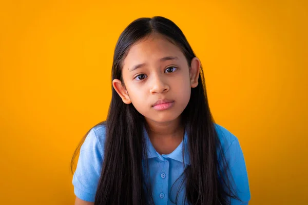 Portrait of serious asian cute girl terisolasi orange background . — Stok Foto
