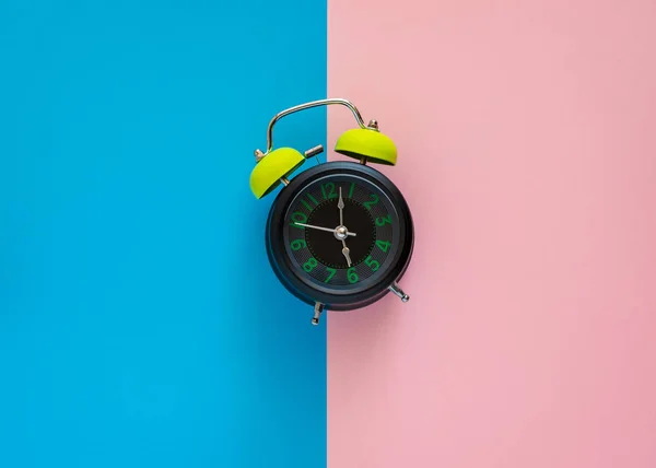 Reloj despertador en dos tonos de papel rosa y azul . — Foto de Stock