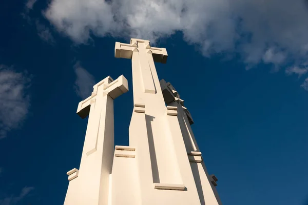 The Three Crosses monument overlooking Vilnius Old Town on sunset. Vilnius landscape from the Hill of Three Crosses, located in Kalnai Park, Lithuania.