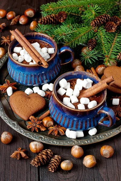 Canecas com chocolate quente e biscoitos de gengibre na mesa de madeira — Fotografia de Stock