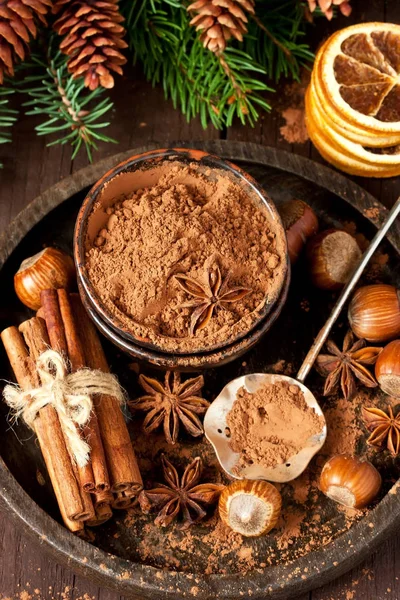 Cocoa powder and spices on wooden background — Stock Photo, Image