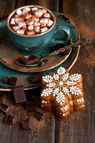 Cup of creamy hot chocolate with melted marshmallows and gingerbread cookies  for christmas holiday