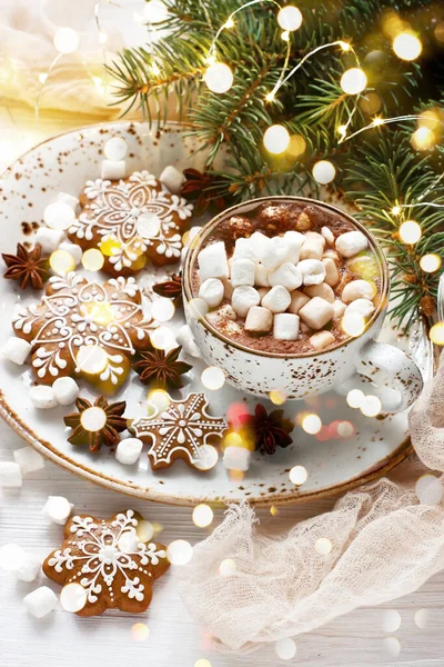 Cup of creamy hot chocolate with melted marshmallows and  gingerbread cookies   for christmas holiday, selective focus, shallow depth of field