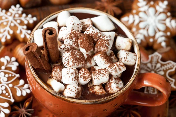 Cup of creamy hot chocolate with melted marshmallows and  gingerbread cookies   for christmas holiday, selective focus, shallow depth of field