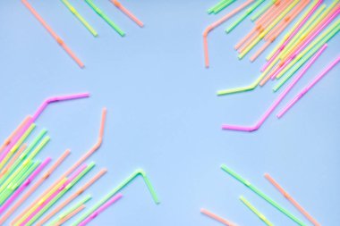 Mavi arka planda renkli plastik pipetler. Kokteyl tüpleri.