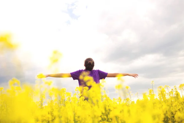 Mujer feliz joven en el campo de canola. Flores de campo amarillo . — Foto de Stock