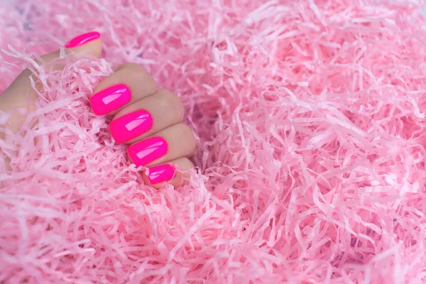 Elegante manicure feminina na moda. Neon plástico rosa unhas no fundo confete . — Fotografia de Stock