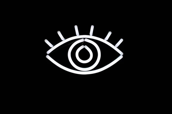 Glowing neon eye on isolated black background. — Stock Photo, Image