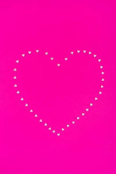 Pink confetti heart on bright pink background. — Stock Photo, Image