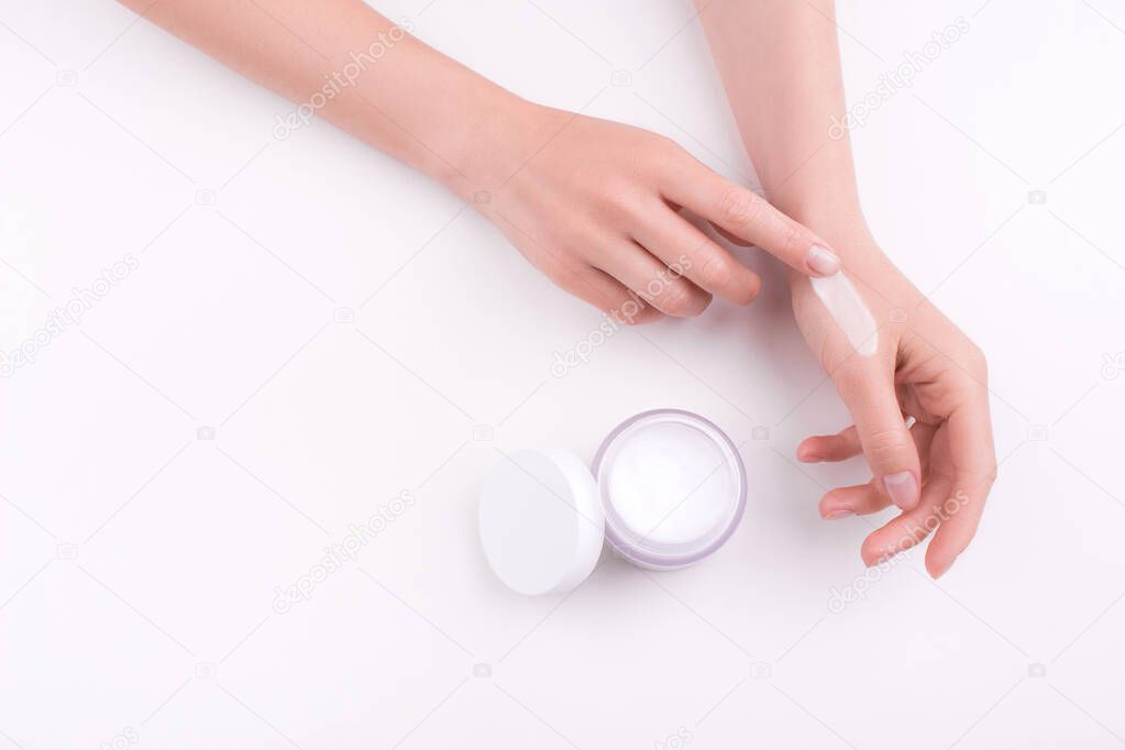 Moisturizing care skincare cream  in an open jar with visible texture. Skin and hand care.  Flat lay, copy space, top view, close up. Natural material. Beauty.