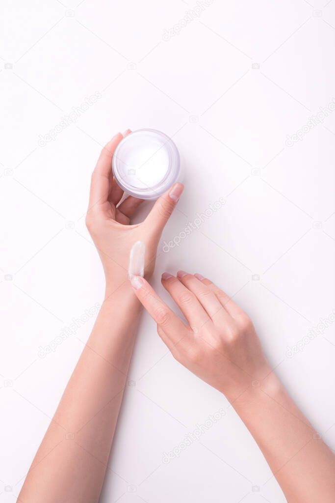 Moisturizing care skincare cream  in an open jar with visible texture. Skin and hand care.  Flat lay, copy space, top view, close up. Natural material. Beauty.