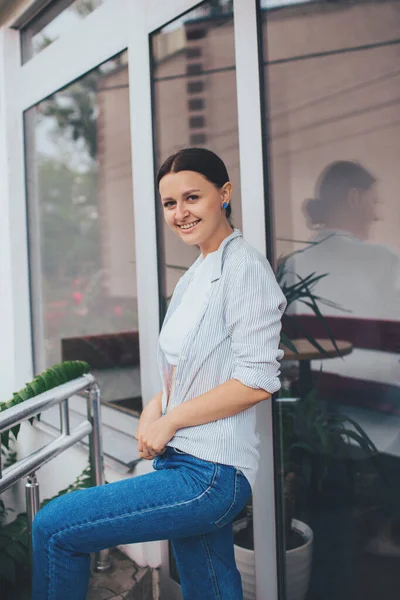 Beautiful smiling girl in casual style. Wearing cute trendy outfit. Urban style.