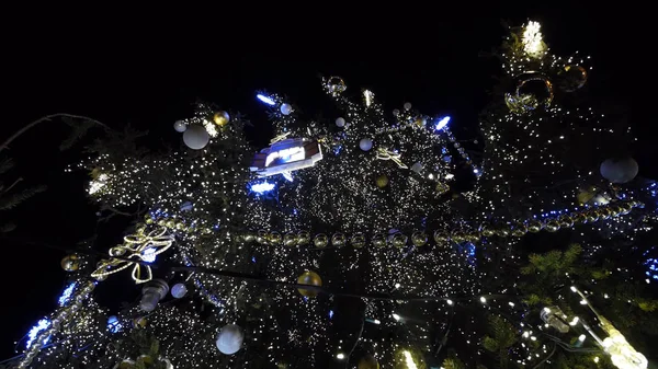 Christmas decorations on a Christmas tree in the form of stars with angels on the background of other decorations