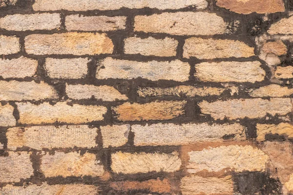 Texture of the old masonry walls made of natural stones and bricks