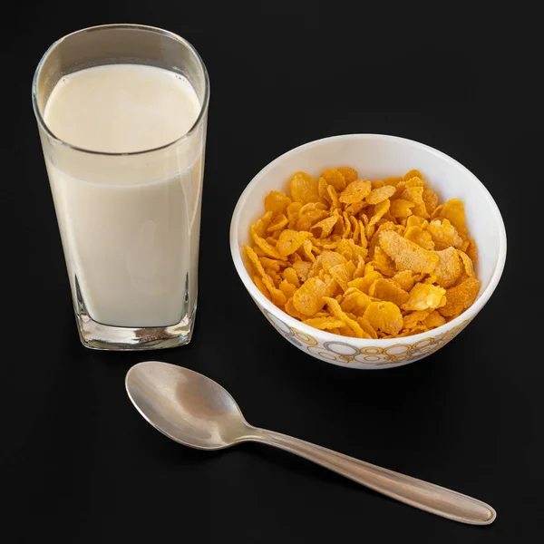 Cornflakes with milk in blowl with glass of milk. — Stock Photo, Image