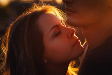 adam ve kız günbatımı arka plan alanında.