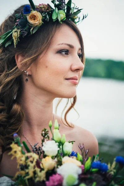 portrait of the bride against the background of the river.